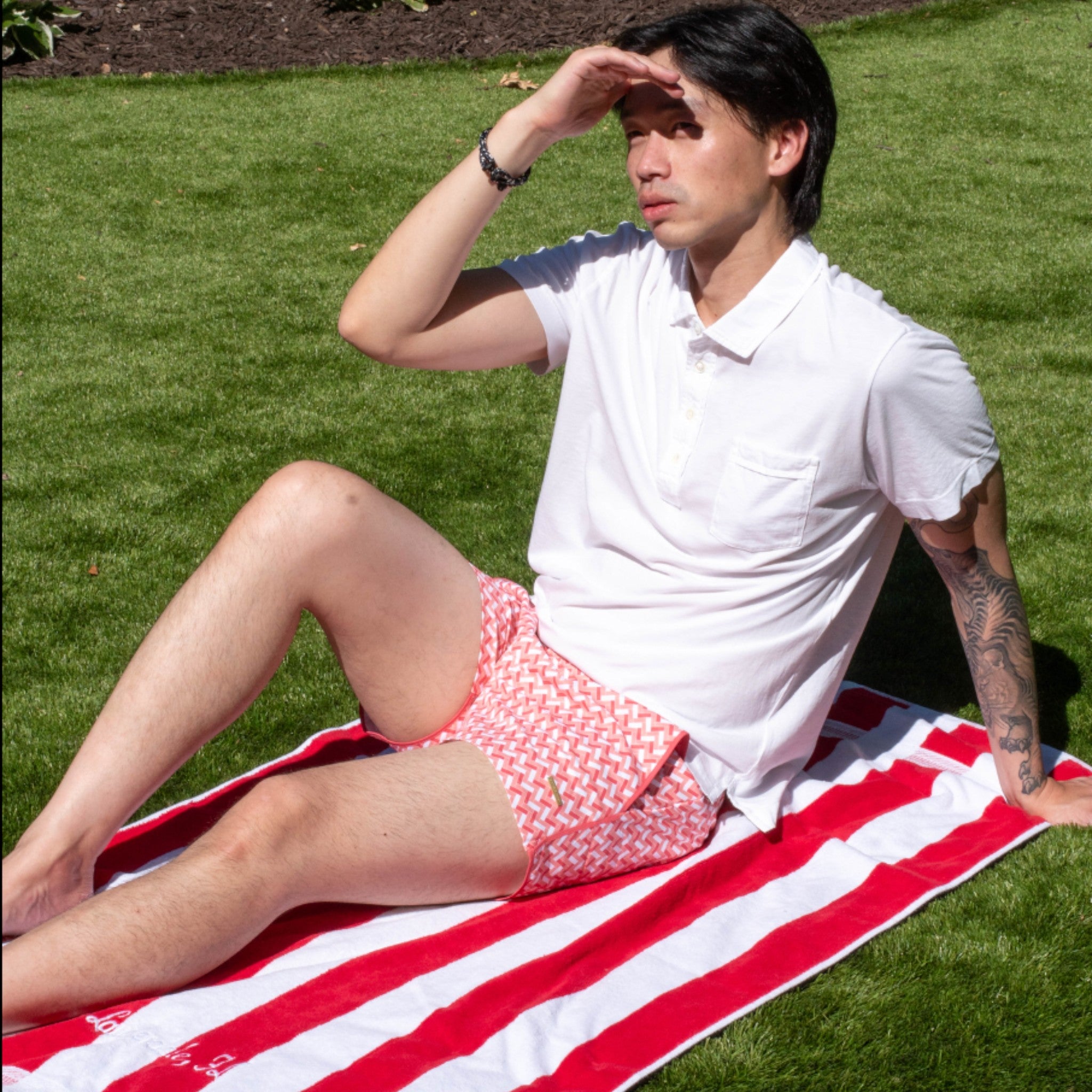 Peach, red, and white patterned swimsuit with button closure