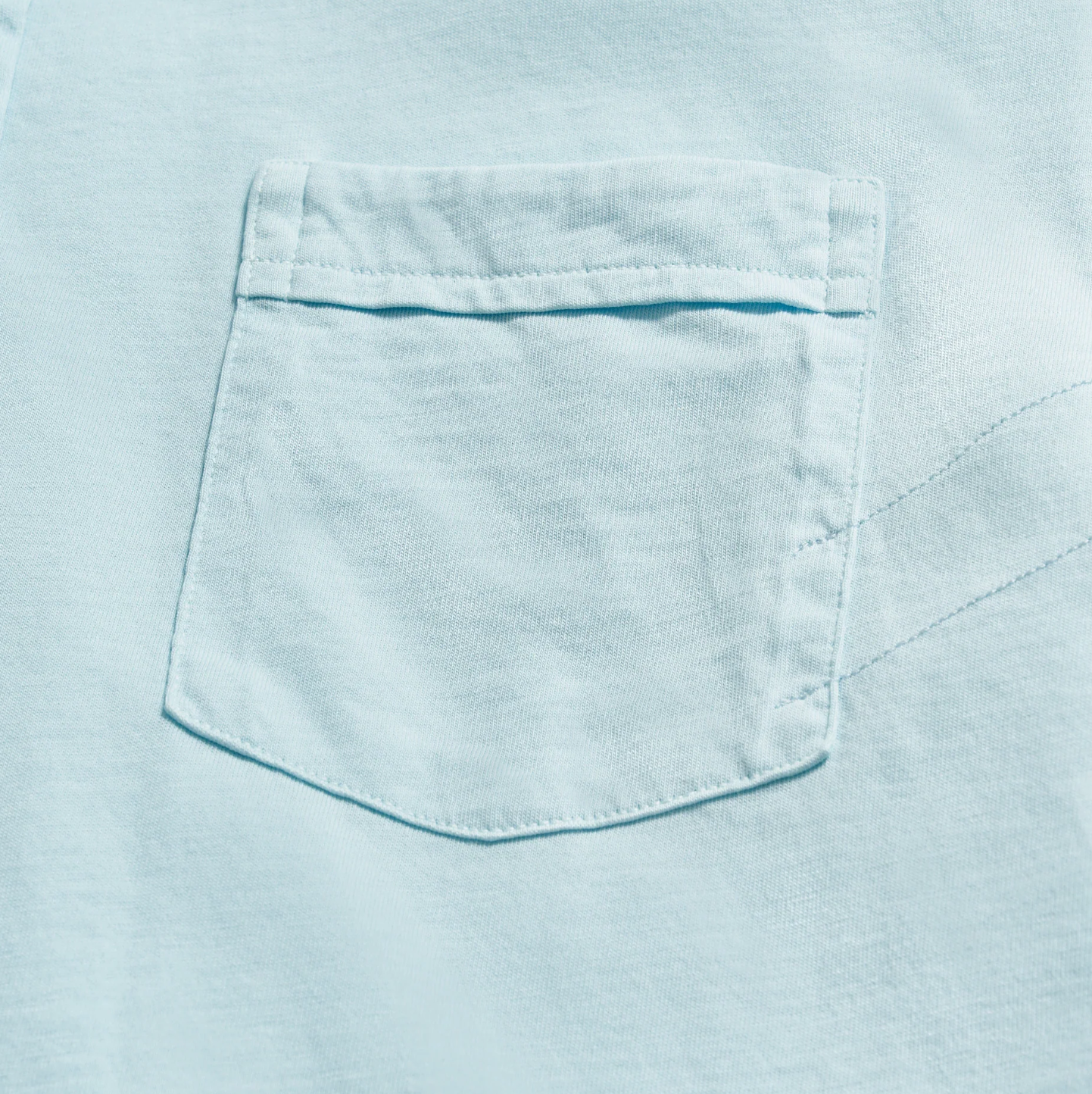 Short sleeve pale blue polo with three buttons and pocket